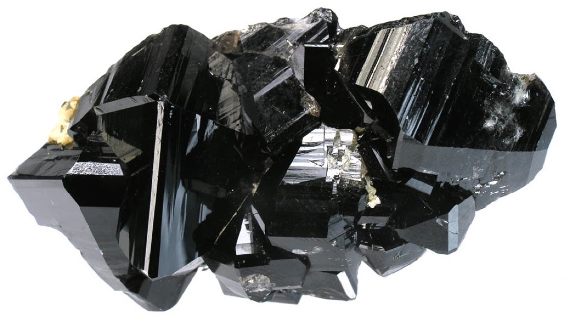 Black crystals of cassiterite, the main ore of tin, on a piece of pale quartz rock.